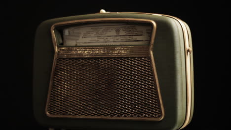 Vintage-Radio-Transistor-From-1960s,-Old-Portable-Device-Spinning-on-Black-Background,-Full-Frame