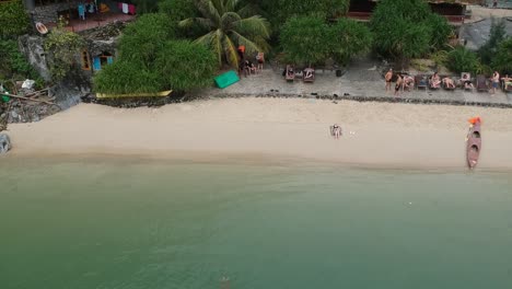 Tourist-Wading-Into-Calm-Waters-At-Freedom-Island,-Vietnam