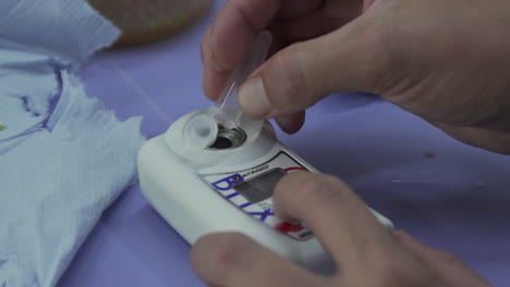 Lab-Worker-Adds-Fluid-from-Tube-Onto-Biological-Seed-Scanner-Device