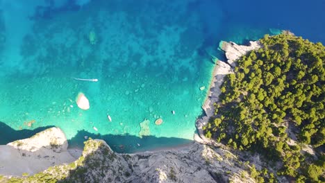 Crystal-clear-waters-along-Oasi-Beach-by-the-Keri-Caves-in-Zakynthos,-Greece,-aerial-view
