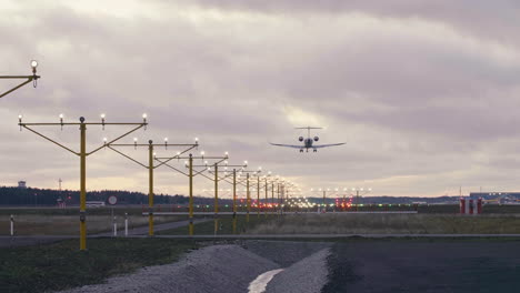 Bombardier-CRJ-900-airliner-landing-at-Tallinn-airport-on-summer-sunset-with-red-clouds