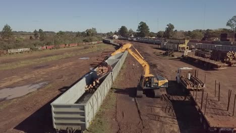 An-industrial-logging-site-with-machinery-and-stacked-timber,-daytime,-aerial-view