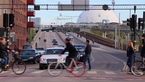 Bicyclists-and-pedestrians-at-crossing-on-trafficked-Stockholm-street
