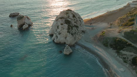 Aphrodite's-Rock-in-aerial-view-on-golden-hour,-Paphos,-Cyprus