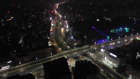 RAJKOT-AERIAL-DRONE-VIEW-Dawn-camera-moving-backwards-showing-lots-of-fore-wheels-and-large-complexes-around