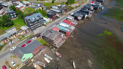 Bird's-eye-view-over-Castro's-palafittes-on-a-sunny-day-at-low-tide,-Chiloé,-Chile
