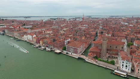 Santa-maria-assunta-church-amidst-venice's-historic-buildings,-overcast,-aerial-view