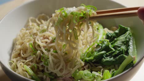 Closeup,-Sticks-grab-Bakmi-wheat-noodles,-Chinese-bowl,-food,-eating-tradition
