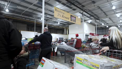 Shoppers-are-queuing-in-checkout-lines-at-the-Hayes-branch-of-Costco-in-London,-England,-illustrating-the-concept-of-consumerism-and-retail-efficiency