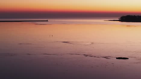 Serene-sunset-over-Port-Colborne-with-calm-waters-and-vibrant-skies,-tranquil-scene