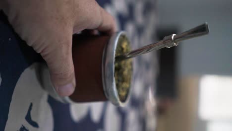 Pouring-hot-water-onto-a-mate,-traditional-Argentinian-beverage