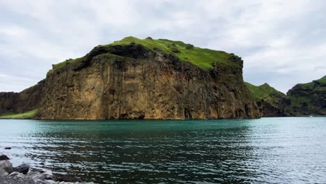 Cliff-side-of-Heimaklettur-in-Westman-islands,-Iceland,-view-from-opposite-shore