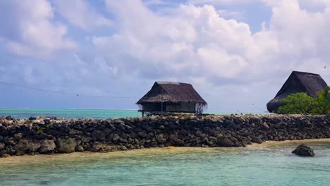 Scenic-view-of-traditional-Micronesian-thatched-roof-houses-on-a-tiny-remote-tropical-island-in-Pohnpei,-Federated-States-of-Micronesia