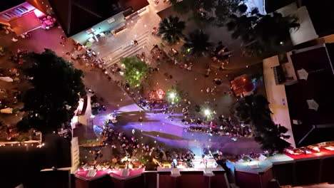 Drone-top-down-pan-across-multicolored-runway-and-string-lights-at-night-in-Kura-Hulanda-village-in-Otrobanda-Willemstad-Curacao