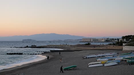 Typical-scenery-in-beachside-town-in-Japan-with-people-walking-dogs-and-Mt