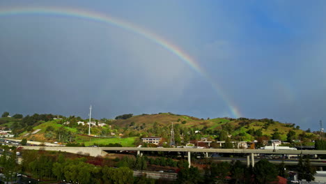 Drone-shot-of-a-rainbow-over-Walnut-Creek,-California-midday