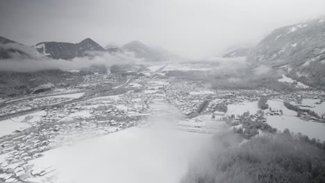 Aerial,-Drone,-Austria,-snow-covered-valley,-flying-through-clouds,-winter