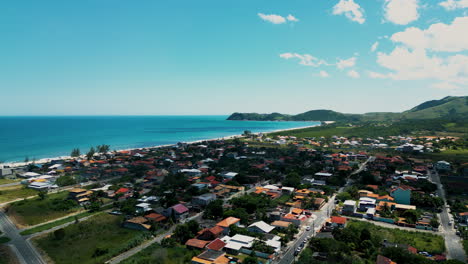 Drone-Footage-of-Jaconé-Beach-and-its-Main-Street-and-Residences-in-Maricá,-Saquarema,-Rio-de-Janeiro---Brazil