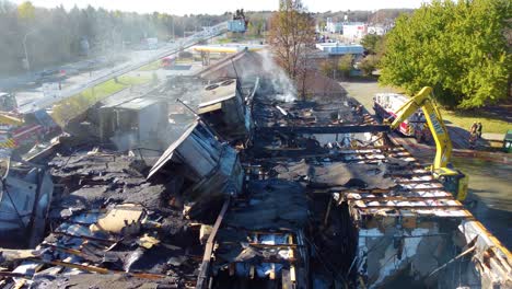 Excavators-Demolishing-The-Burned-Building-After-The-Fire-In-Blainville,-Québec,-Canada