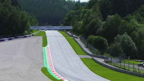 Red-Bull-Ring-circuit-view,-race-car-driving-fast-into-the-mountain-view