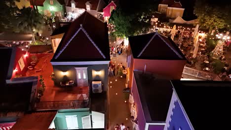 Drone-aerial-dolly-establishes-crowded-side-streets-in-Kura-Hulanda-village-in-Otrobanda-Willemstad-Curacao-at-night