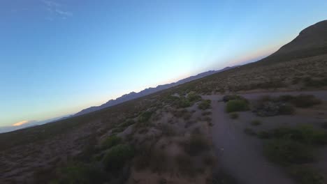 FPV-Drone-Flying-over-Desert-and-Mountains-in-El-Paso,-TX-during-Sunset