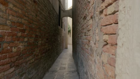 Narrow-Venetian-Alleyway-Between-Brick-Walls