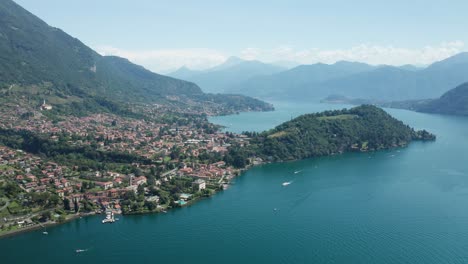 Lake-como-with-ossuccio-and-lenno,-italy,-surrounded-by-mountains,-aerial-view