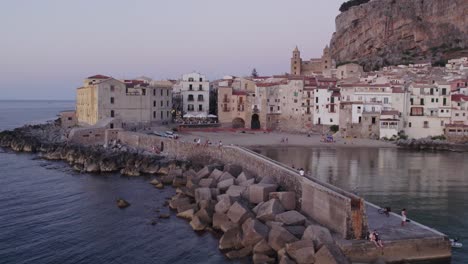 Aerial-view-of-Cefalu-medieval-city-during-summer-at-sunset,-Sicily,-Italy