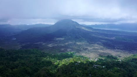 Mount-Batur-comes-into-view-from-under-the-Clouds-near-Kintamani-Village---BALI,-Indonesia