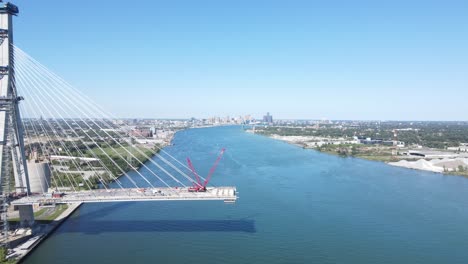 Gordie-Howe-international-bridge-construction-site-on-sunny-day,-aerial-side-view