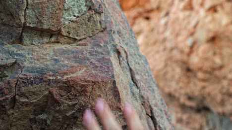 Helpless-female-hand-reaches-on-the-rock-and-slips-down,-falling-concept