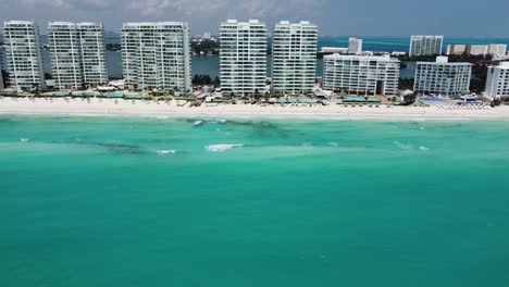 Cancun's-turquoise-waters-and-beachfront-resorts,-sunny-day,-aerial-view