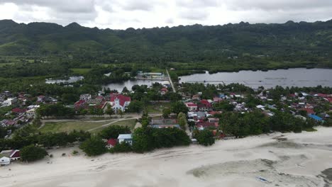 Aerial-Drone-Fly-Above-Coastal-Village-Town-and-Landscape-in-anda-Phillipines,-Cloudy-Skyline