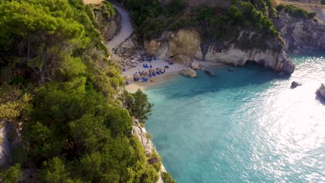Xigia-beach-with-turquoise-waters-in-zakynthos,-greece,-surrounded-by-green-cliffs,-aerial-view
