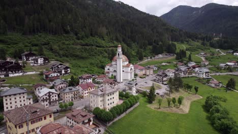 Aerial-orbit-Parrocchia-di-San-Lucano-Vescovo-historical-church,-Dolomites
