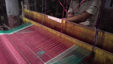 A-weaver-weaves-cloth-in-an-ancient-way