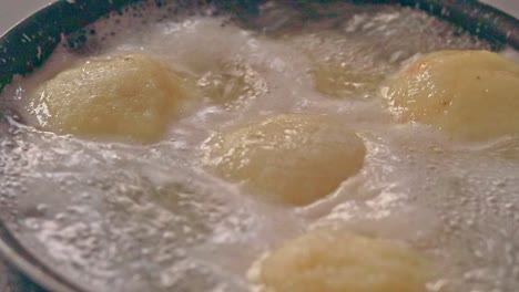 Ambient-motion-of-traditional-german-potato-dumplings-boiling-in-a-pot-showing-the-candid-peaceful-moment-of-home-life-and-winter-comfort-food