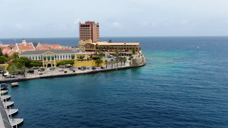 Aerial-pullback-along-famed-pontoon-bridge-of-Willemstad-Curacao-and-historic-government-buildings
