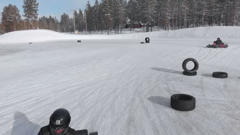 Winter-snow-track-for-go-karts-sliding-through-corners,-crash-on-tires