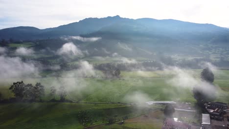 Aerial-Panorama-of-Natural-Landscape-with-Mist-and-Background-of-Pasochoa-Volcano