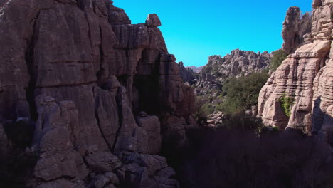 Aerial-forward-shot-moving-between-the-rocks-of-nature-reserve-at-El-Torcal-de-Antequera,-Malaga,-Andalusia,-Spain