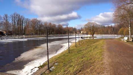 Rushing-water-in-river-Gauja-with-gates-for-kayaking-sport,-sunny-winter-day