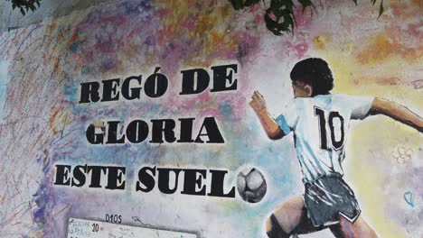 Street-Painted-Artwork-of-Diego-Armando-Maradona-in-the-streets-of-Buenos-aires-city-Argentina,-famous-soccer-player-author-of-the-"Hand-of-God