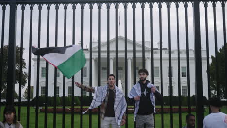 Two-Arab-Men-Waving-a-Palestine-Flag-in-Front-of-the-White-House-at-a-Pro-Palestine-Protest-in-D