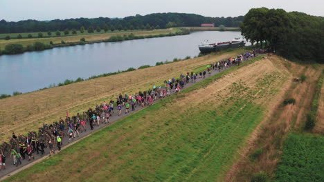 Long-line-of-walkers-during-the-Four-Days-Marches-Nijmegen,-Dutch,-aerial-shot