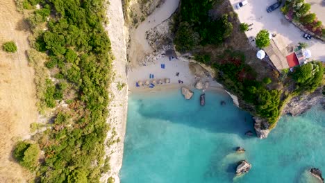 Xigia-beach-in-zakynthos,-greece-with-turquoise-waters-and-beachgoers,-aerial-view