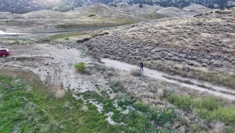 older-man-walking-his-dog-along-the-bank-of-Lake-Isabella-in-california-at-sunset-60fps