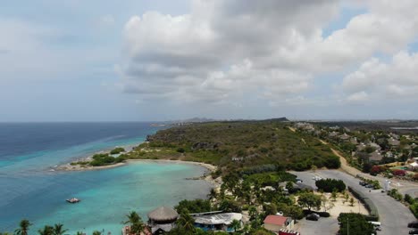 Jan-thiel-bay-in-curacao-with-clear-turquoise-waters-and-lush-coastline,-aerial-view