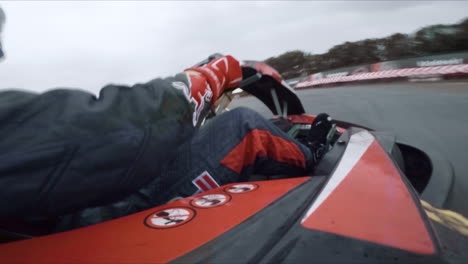 Onboard-side-view-of-professional-race-kart-driver-going-through-corners